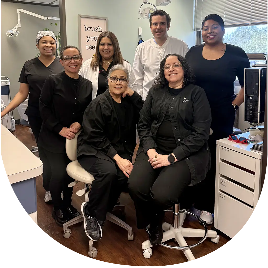 The dedicated and friendly dental team smiling together inside the Sparkle House Dental clinic.