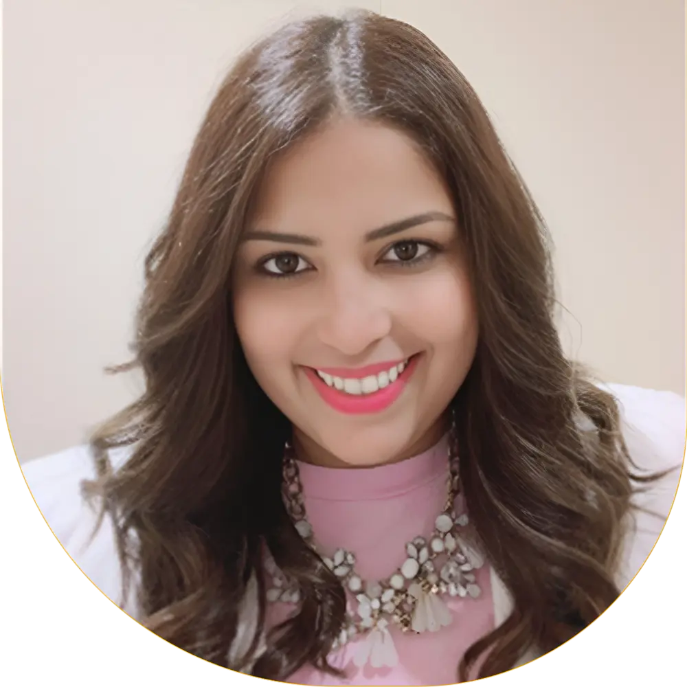 Professional portrait of our experienced female dentist smiling warmly in her modern clinic.